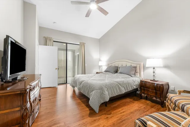 a spacious bedroom with a bed and a flat screen tv