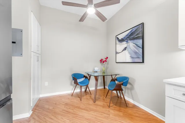 a workspace room with furniture and wooden floor