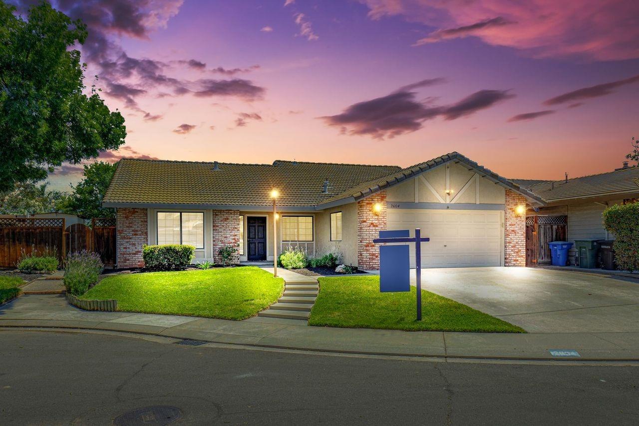 a view of a house with a yard and garage