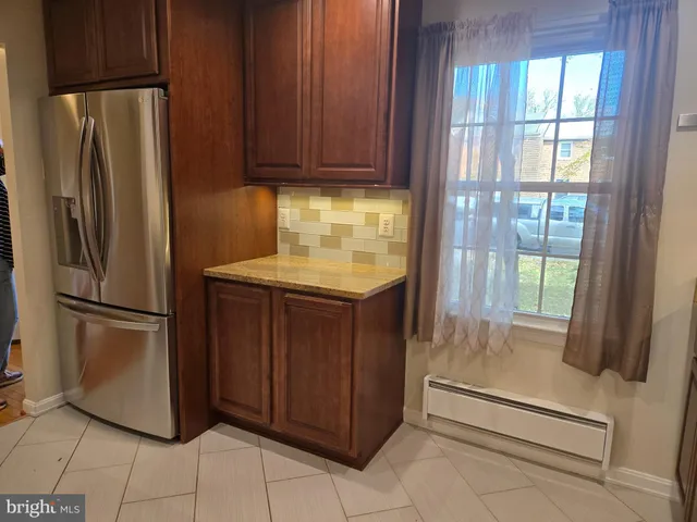 a kitchen with a refrigerator and cabinets
