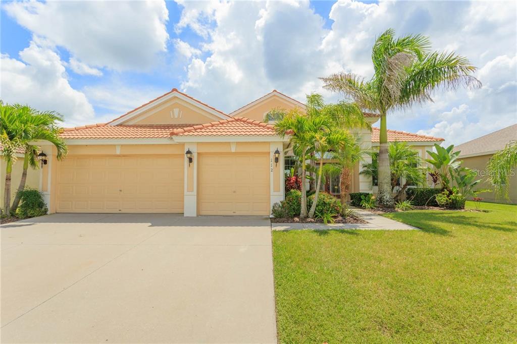 112 Star Shell Drive Apollo Beach, FL 33572 - Photo 1 of 1 a front view of a house with a yard and garage