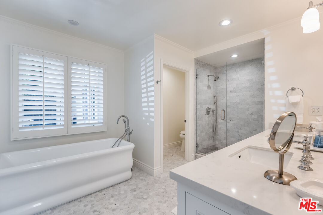 28925 Cliffside Drive Malibu, CA 90265 - Photo 27 of 62 a bathroom with a tub sink and mirror