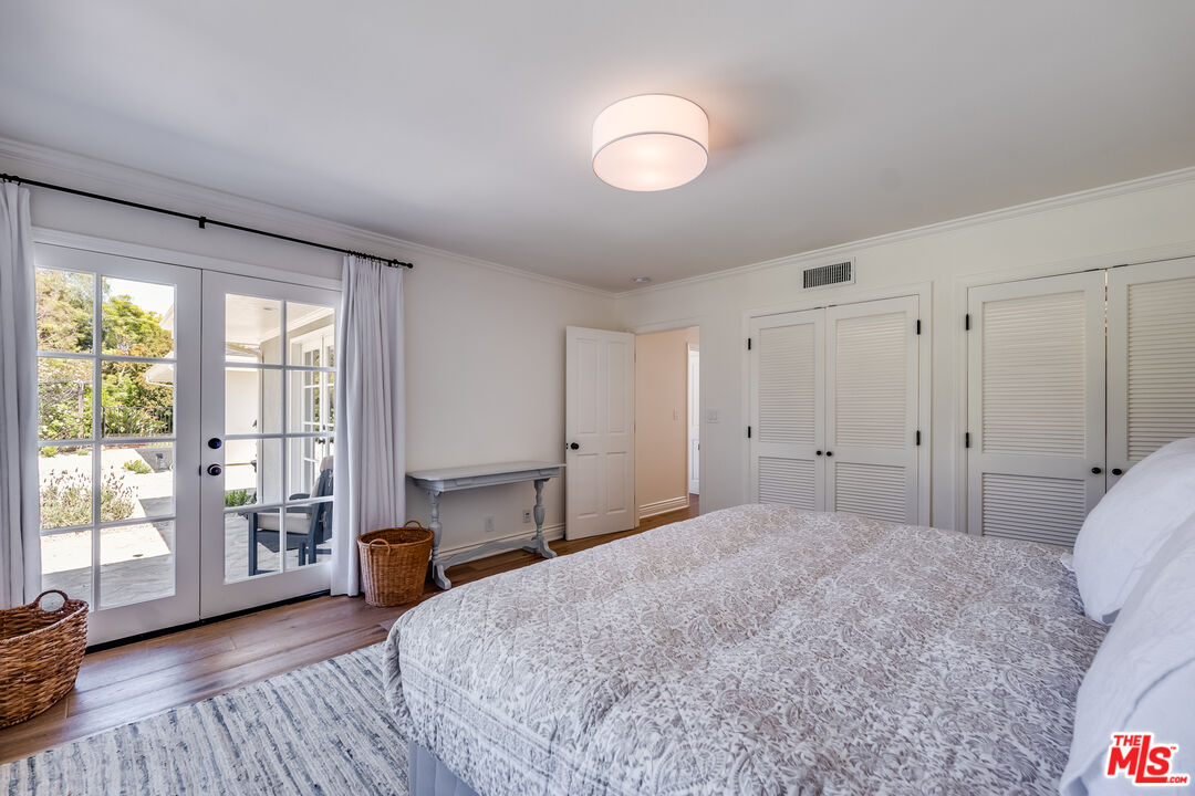 28925 Cliffside Drive Malibu, CA 90265 - Photo 32 of 62 a spacious bedroom with a bed and wooden floor