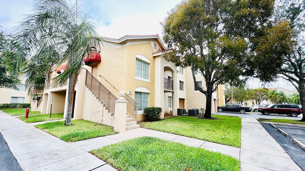 4115 San Marino Boulevard, Unit 101 West Palm Beach, FL 33409 - Photo 1 of 25 a city street lined with buildings and trees