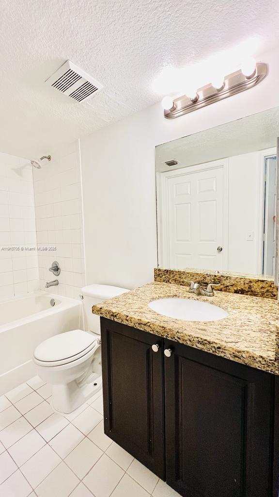 4115 San Marino Boulevard, Unit 101 West Palm Beach, FL 33409 - Photo 18 of 25 a bathroom with a granite countertop sink toilet and shower