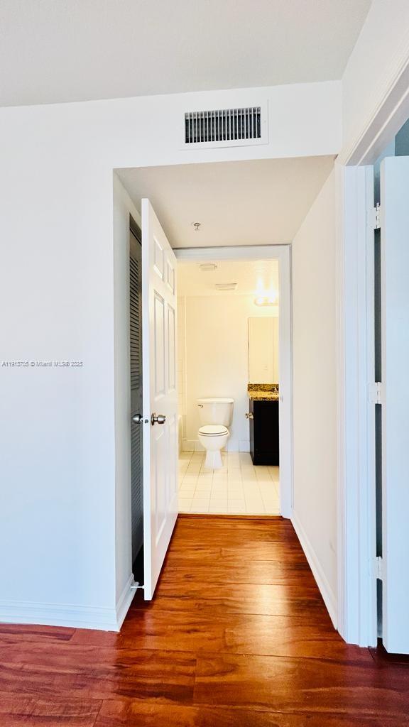4115 San Marino Boulevard, Unit 101 West Palm Beach, FL 33409 - Photo 19 of 25 a view of a hallway with wooden floor and staircase