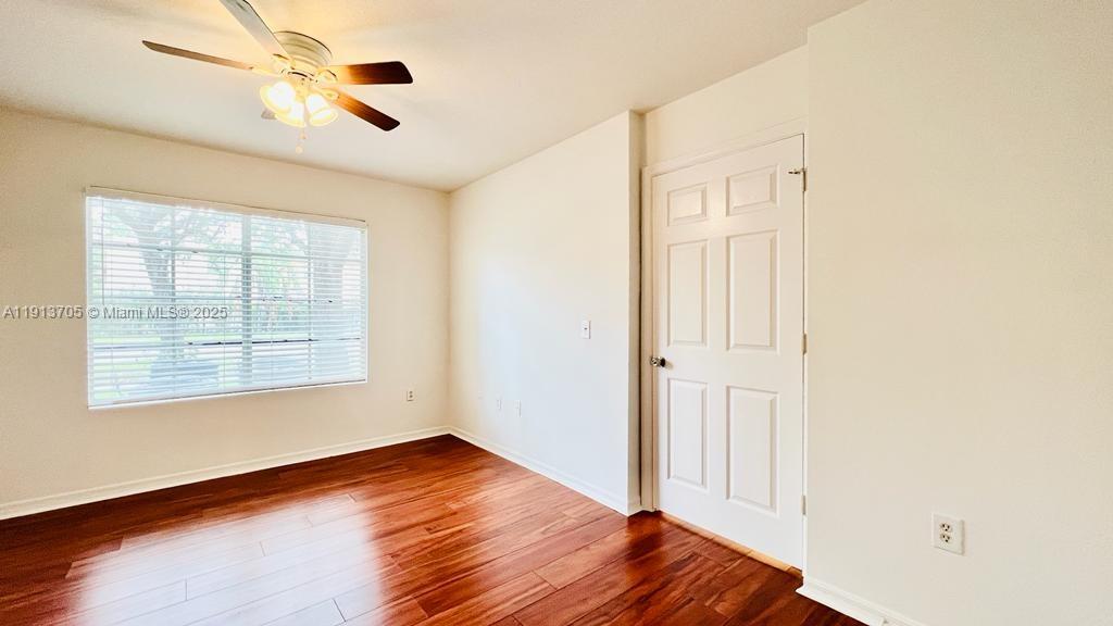 4115 San Marino Boulevard, Unit 101 West Palm Beach, FL 33409 - Photo 24 of 25 a view of an empty room with wooden floor and a window