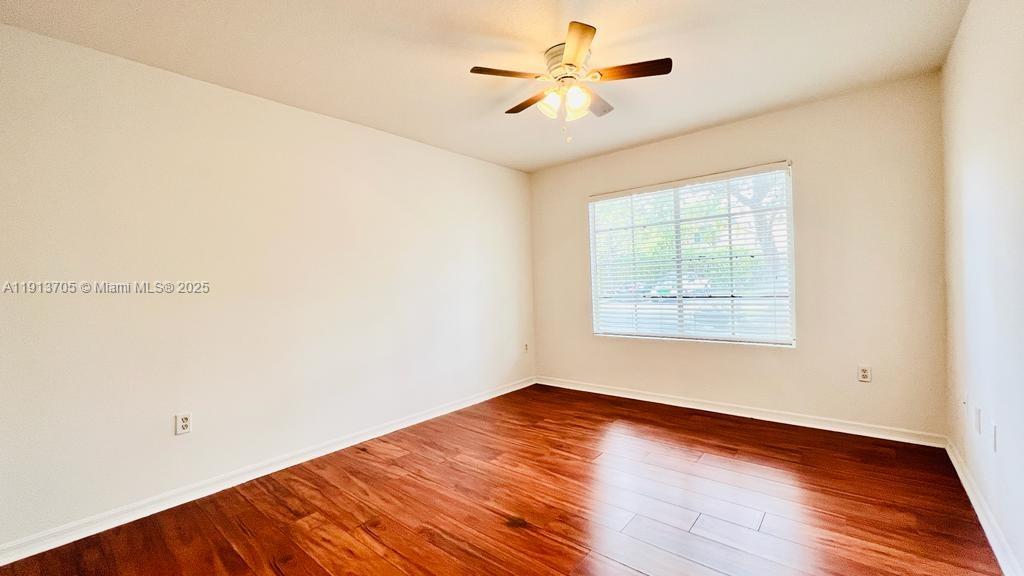 4115 San Marino Boulevard, Unit 101 West Palm Beach, FL 33409 - Photo 25 of 25 an empty room with wooden floor and windows