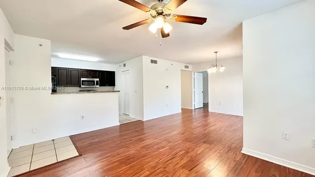 a view of a kitchen with a microwave and a ceiling fan