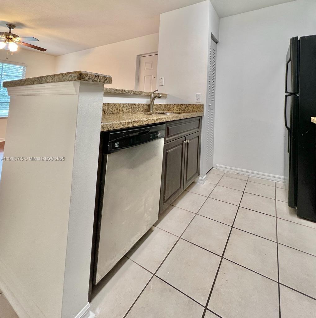 4115 San Marino Boulevard, Unit 101 West Palm Beach, FL 33409 - Photo 9 of 25 a kitchen with stainless steel appliances granite countertop a refrigerator and a stove