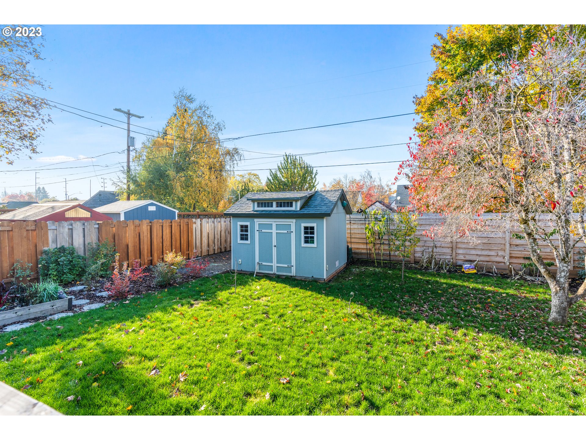 1565 18th Street Northeast Salem, OR 97301 - Photo 37 of 41 a view of a backyard with potted plants and large tree