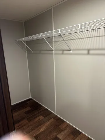 a view of storage and utility room with wooden floor