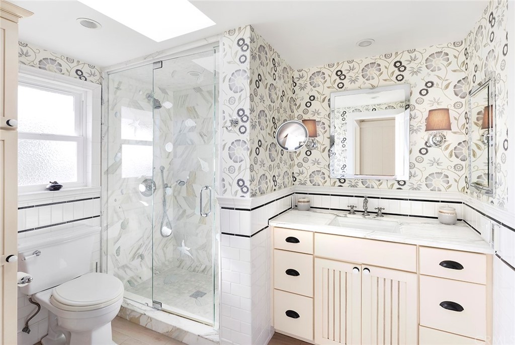 151 Rockledge Terrace Laguna Beach, CA 92651 - Photo 11 of 24 a bathroom with a sink a toilet and shower