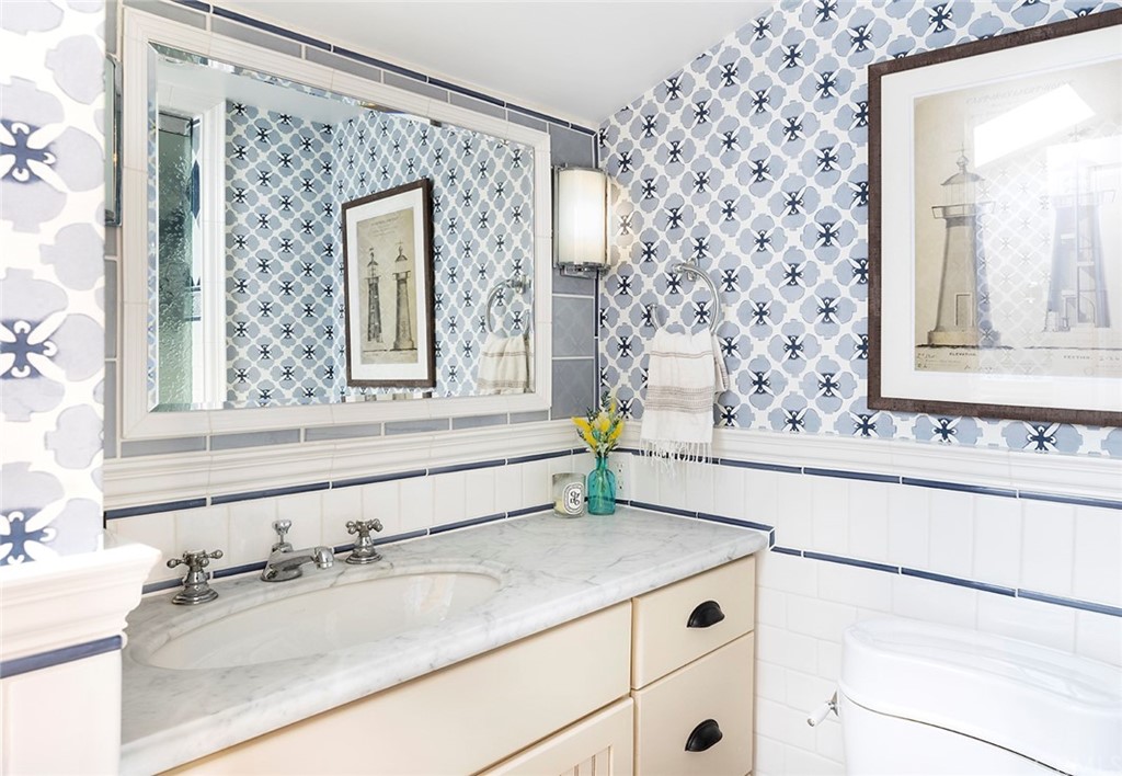 151 Rockledge Terrace Laguna Beach, CA 92651 - Photo 14 of 24 a bathroom with a granite countertop sink and a mirror