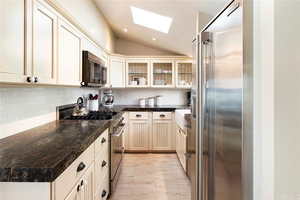151 Rockledge Terrace Laguna Beach, CA 92651 - Photo 9 of 24 a kitchen with stainless steel appliances granite countertop a refrigerator a stove and a sink