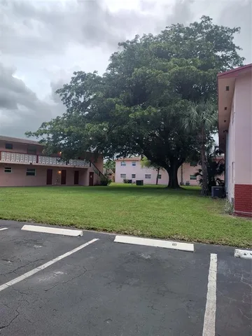 a view of a park with large trees