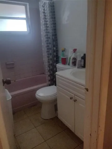 a bathroom with a toilet a sink and a shower