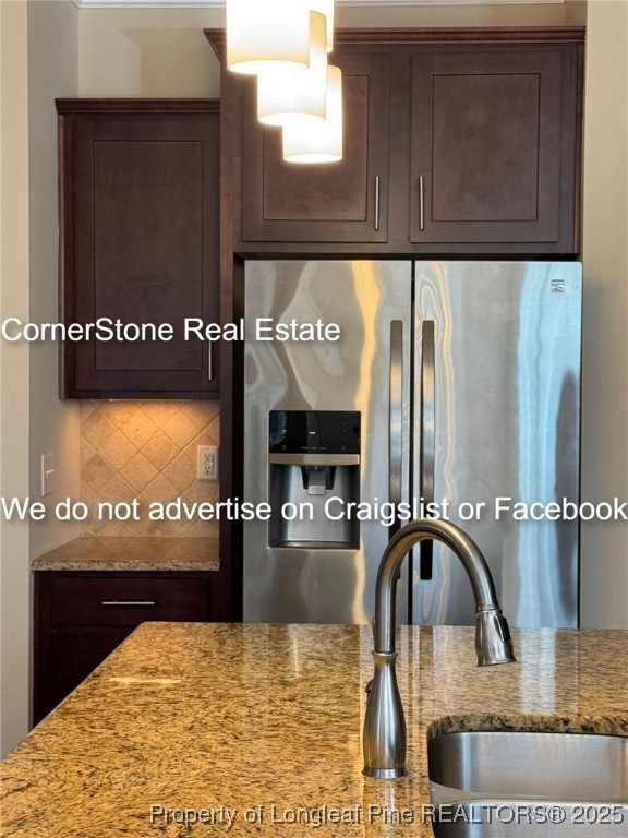 547 Micahs Way North Spring Lake, NC 28390 - Photo 11 of 26 a kitchen with kitchen island granite countertop a refrigerator and a stove
