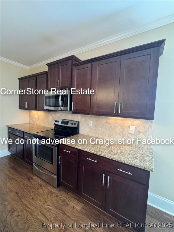 547 Micahs Way North Spring Lake, NC 28390 - Photo 13 of 26 a kitchen with granite countertop lots of wooden cabinets