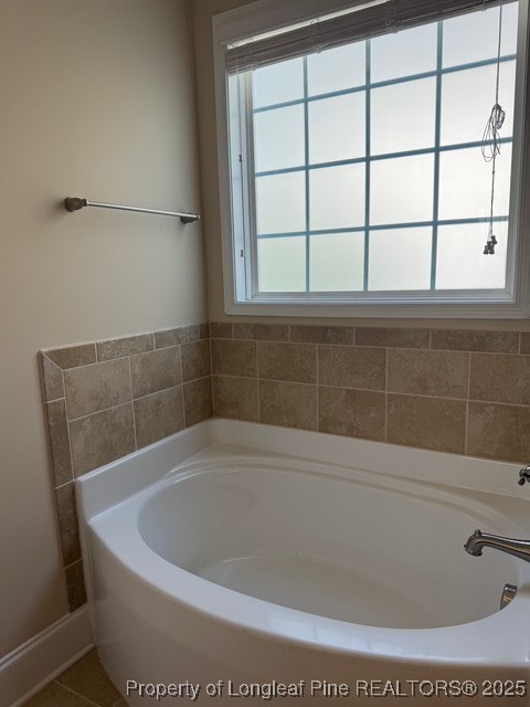 547 Micahs Way North Spring Lake, NC 28390 - Photo 21 of 26 a bath tub sitting in a bathroom next to a window