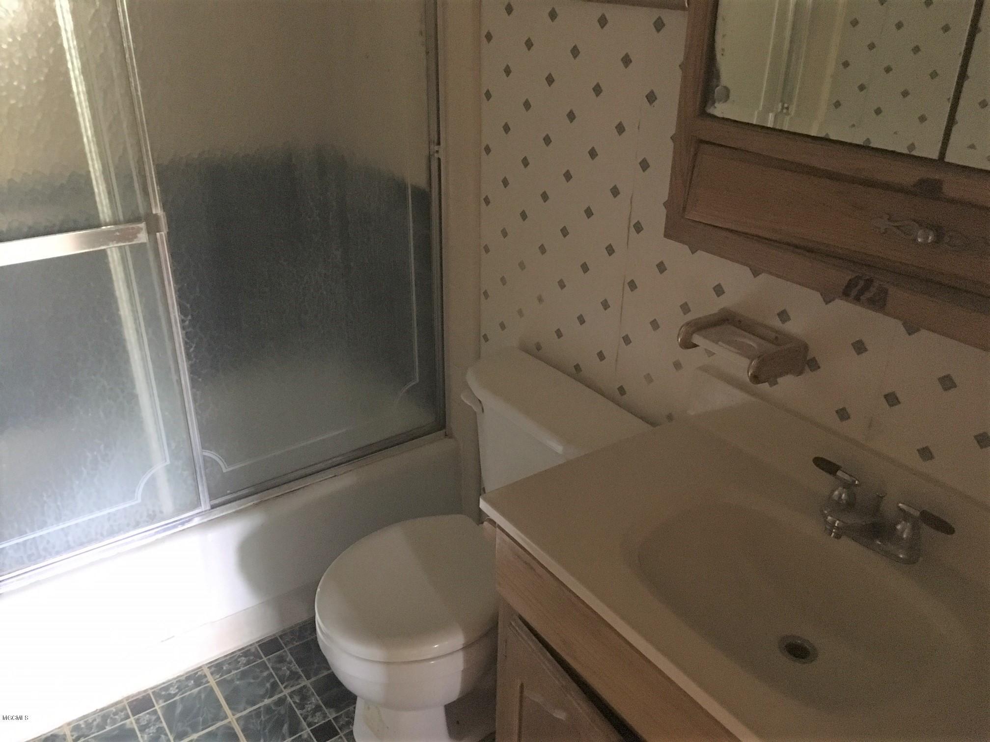 12319 Dedeaux Road Gulfport, MS 39503 - Photo 11 of 14 Hall Bathroom