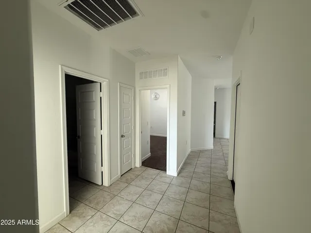 en empty room with windows and fan