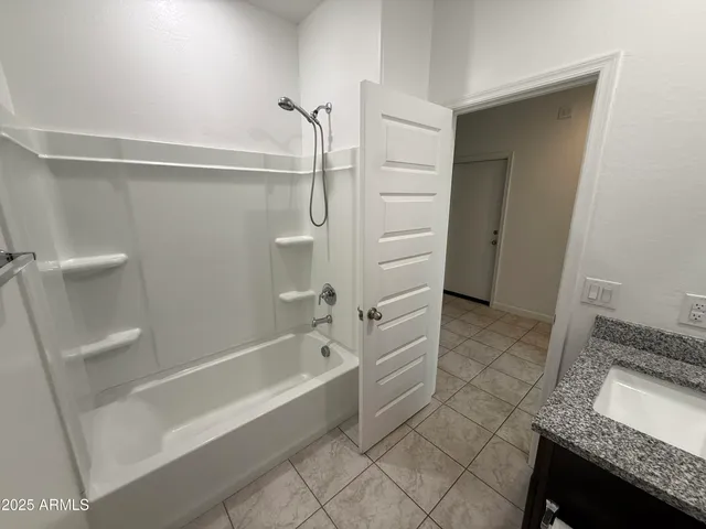 a kitchen with granite countertop a sink and a stove