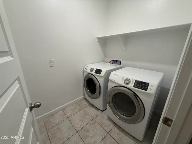 a view of empty room with kitchen