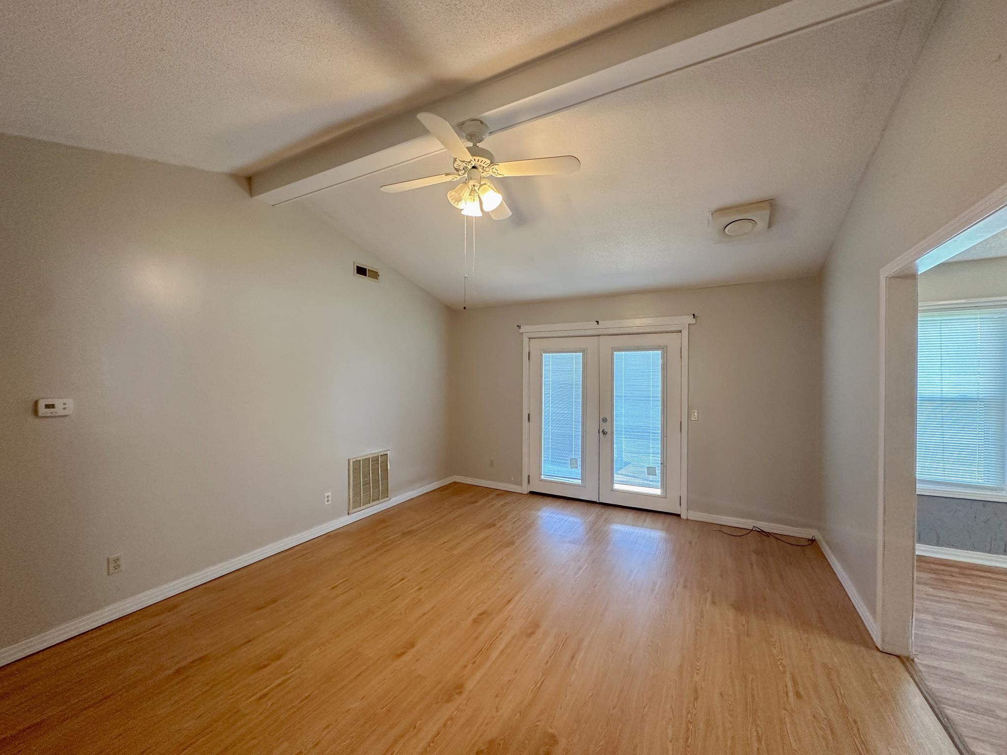 32 County Road 178 Iuka, MS 38852 - Photo 3 of 16 a view of an empty room with wooden floor and a window