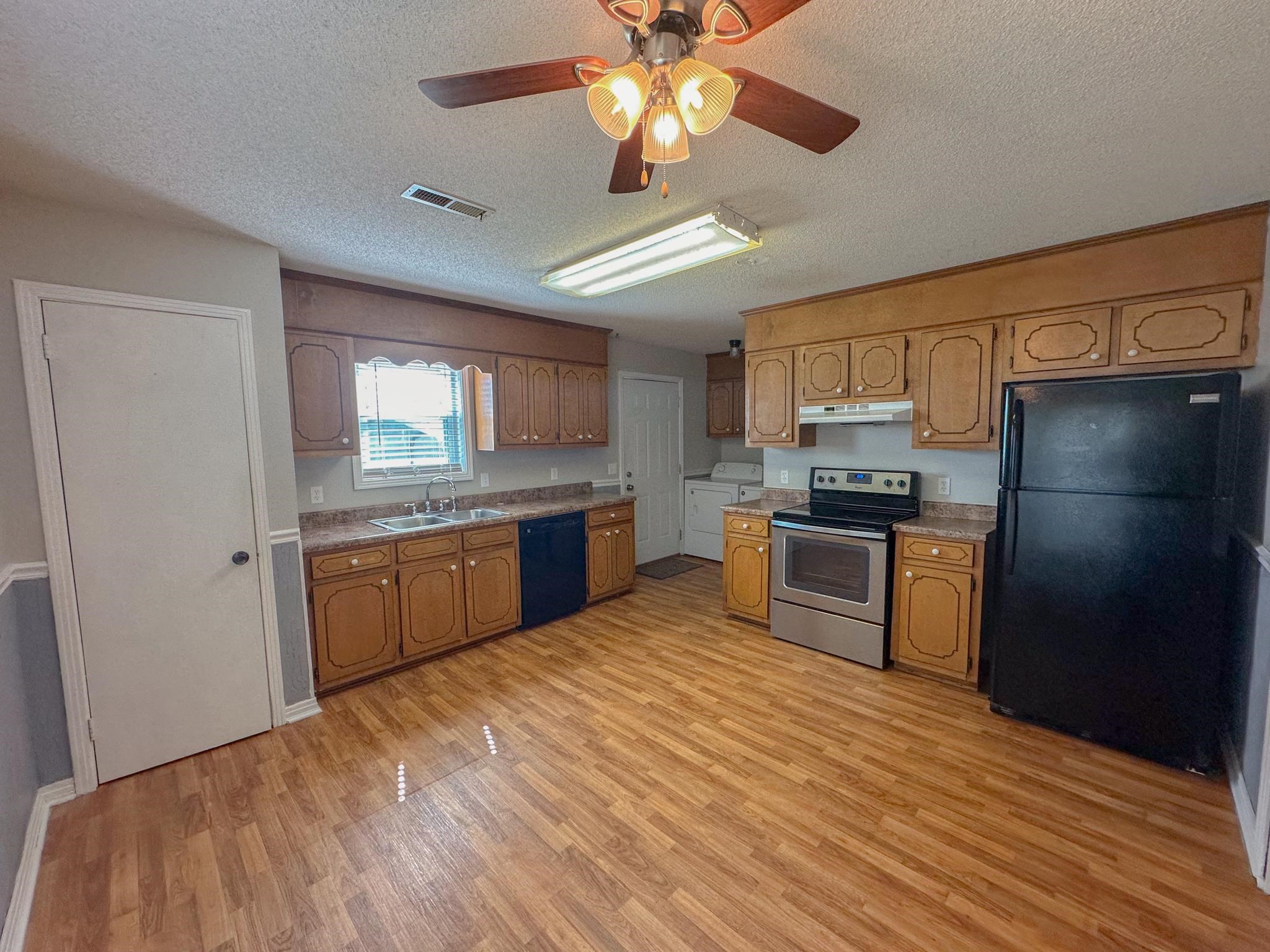 32 County Road 178 Iuka, MS 38852 - Photo 4 of 16 a kitchen with a refrigerator a sink dishwasher with a stove and cabinets
