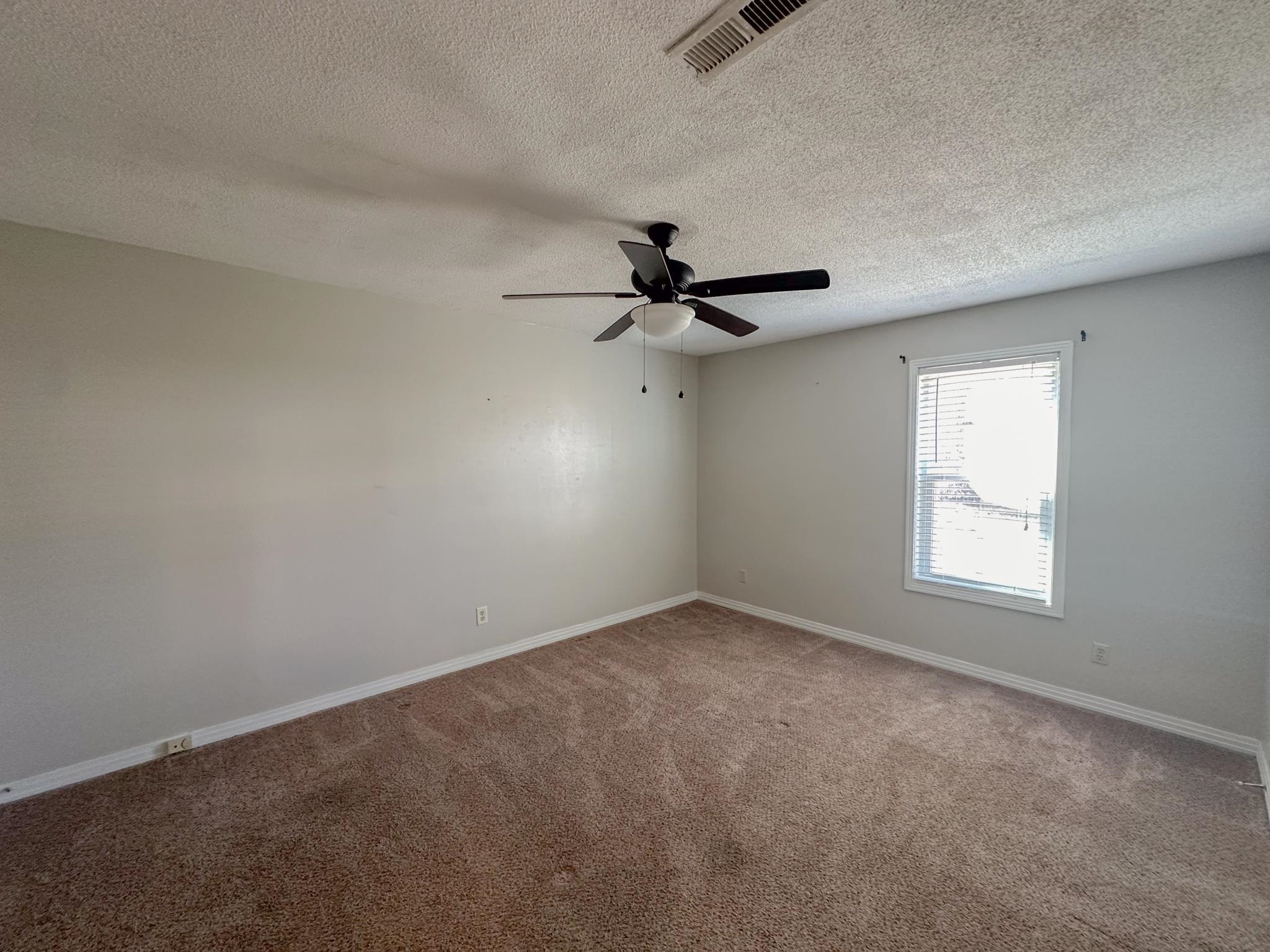 32 County Road 178 Iuka, MS 38852 - Photo 5 of 16 an empty room with a window and a fan