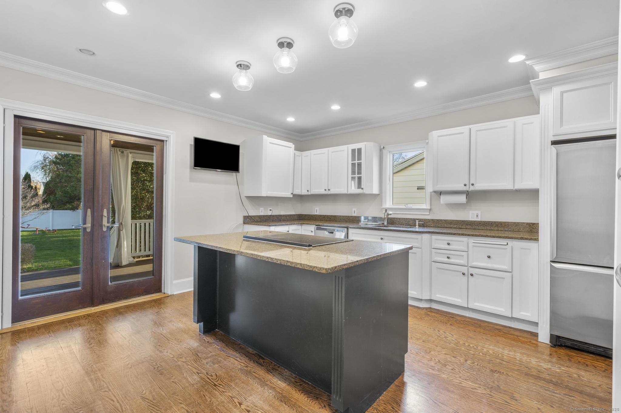 447 Reef Road Fairfield, CT 06824 - Photo 11 of 27 a kitchen with stainless steel appliances granite countertop a stove a sink and a refrigerator