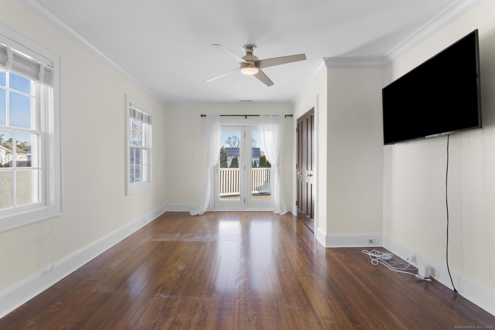 447 Reef Road Fairfield, CT 06824 - Photo 13 of 27 a view of a livingroom with wooden floor and a flat screen tv