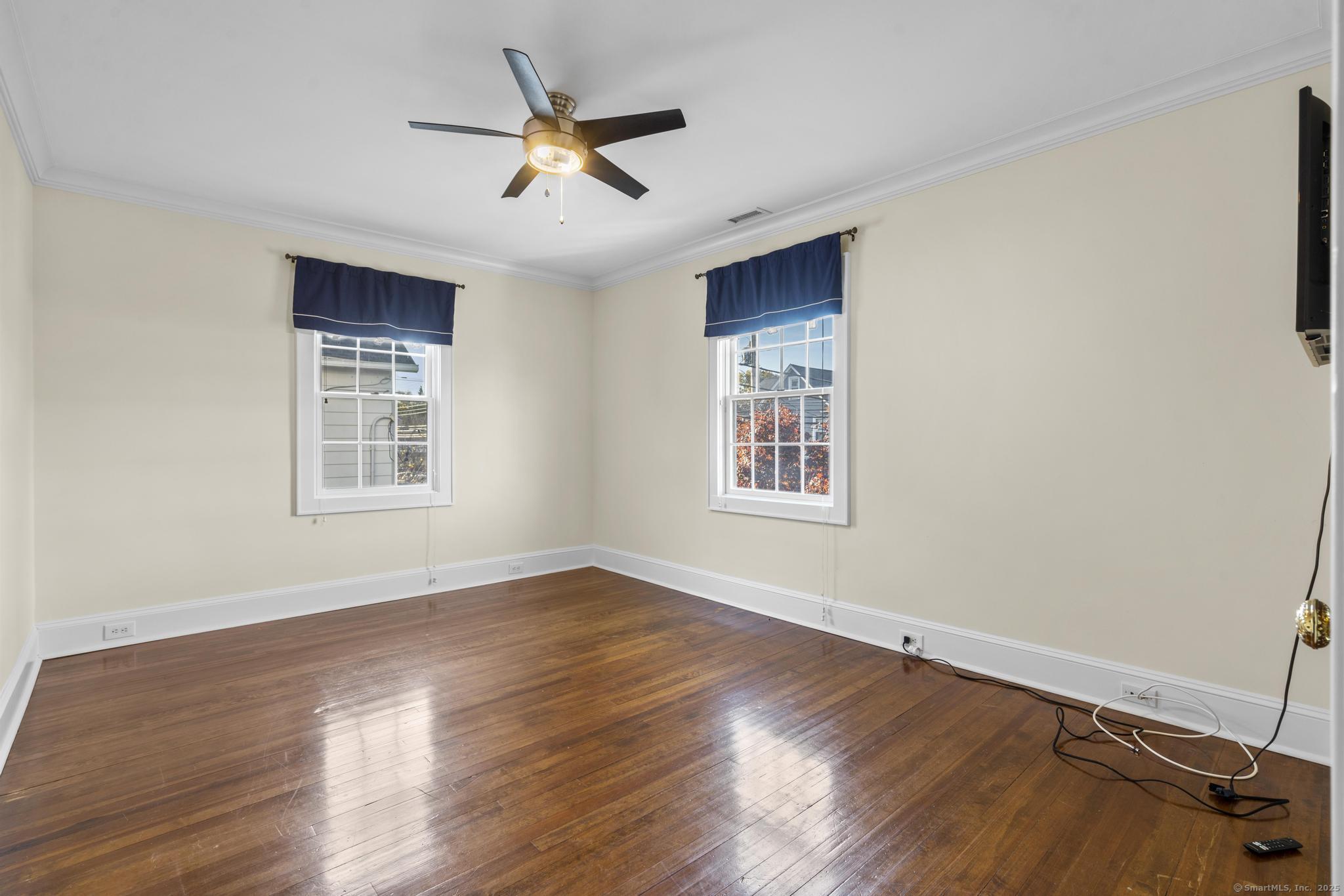 447 Reef Road Fairfield, CT 06824 - Photo 22 of 27 a view of a livingroom with a ceiling fan and wooden floor