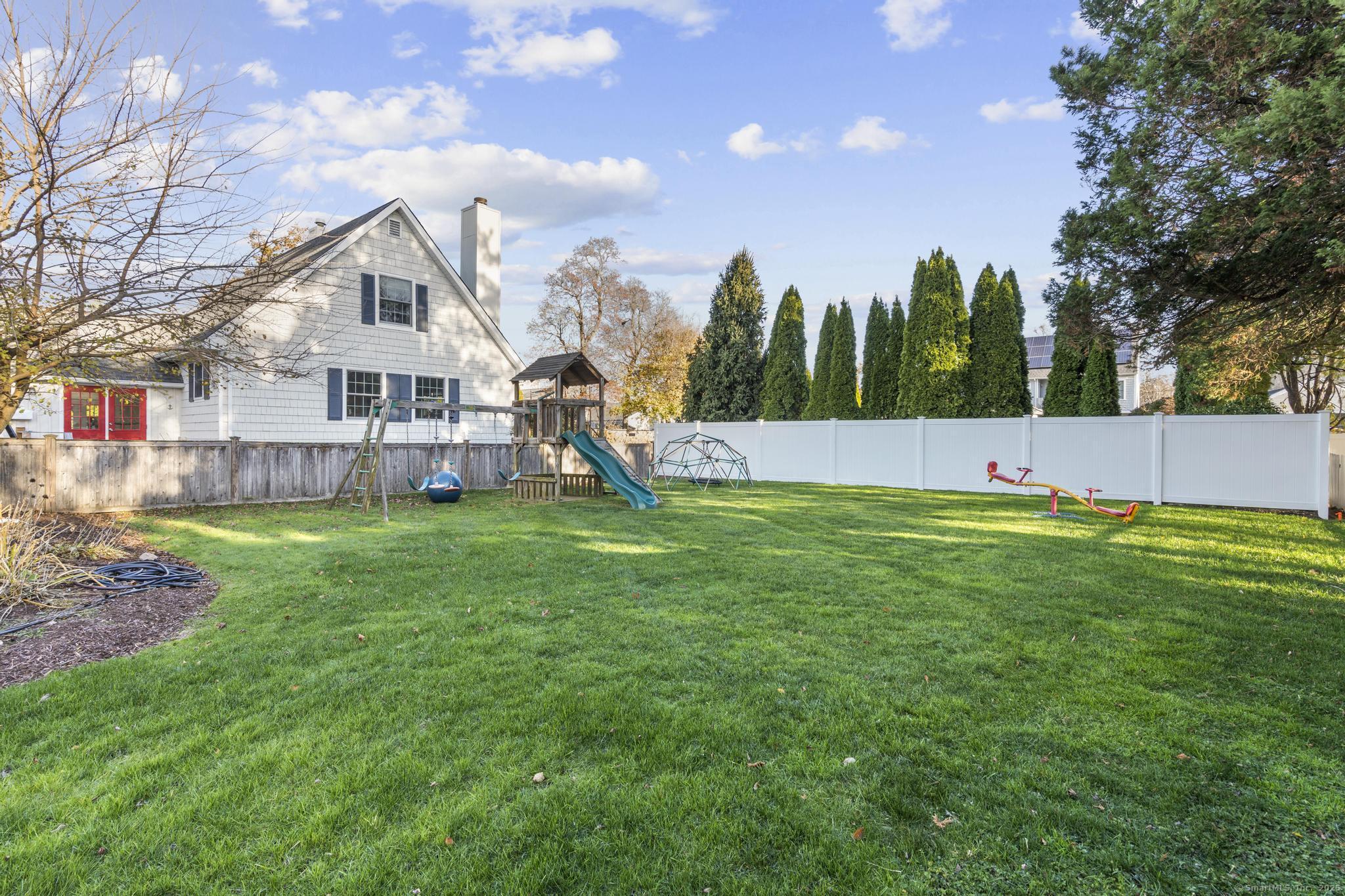 447 Reef Road Fairfield, CT 06824 - Photo 27 of 27 a view of a house with a backyard and a tree