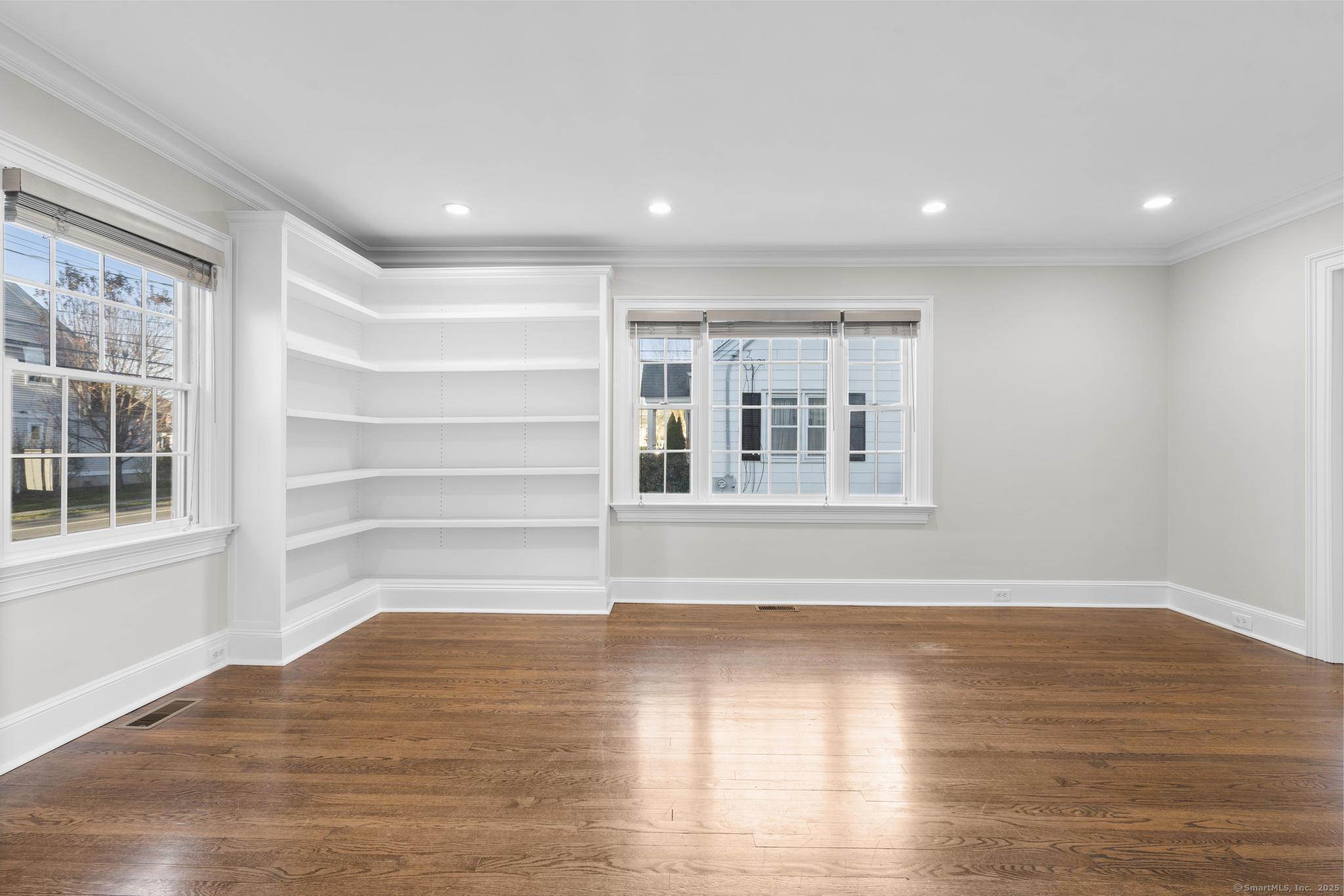 447 Reef Road Fairfield, CT 06824 - Photo 4 of 27 a view of empty room with wooden floor and windows