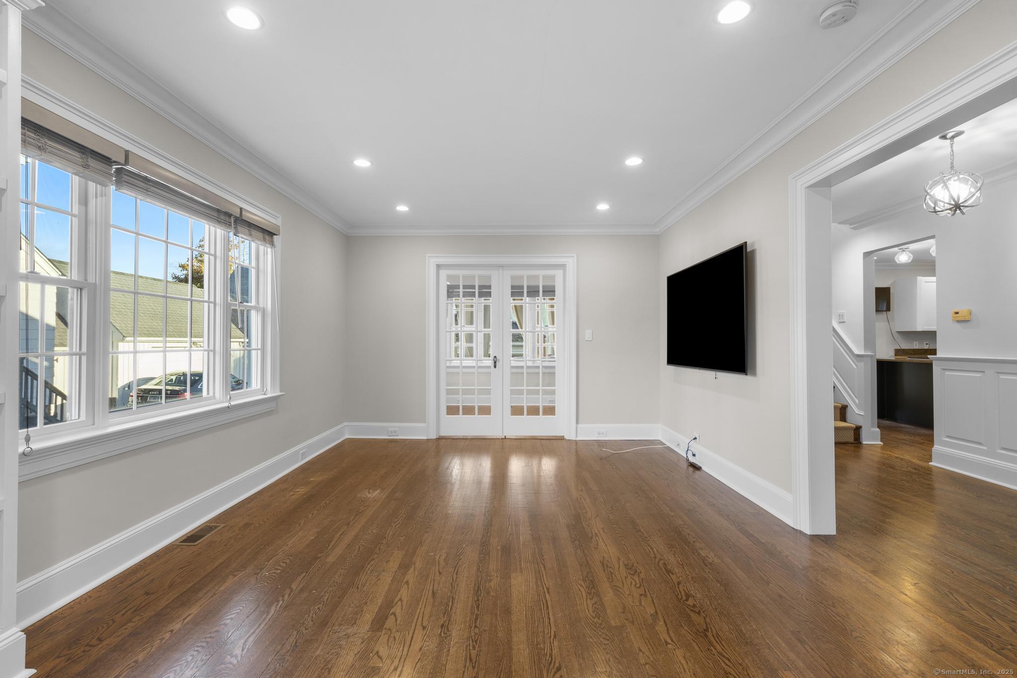 447 Reef Road Fairfield, CT 06824 - Photo 5 of 27 a view of a big room with wooden floor and windows