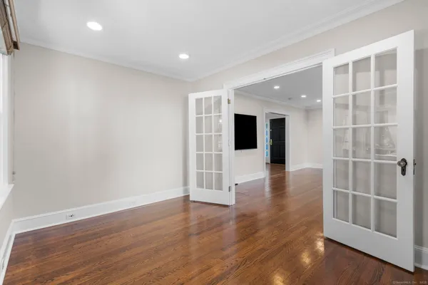 wooden floor in an empty room with a window