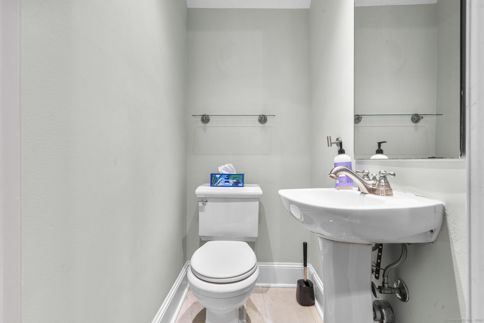 447 Reef Road Fairfield, CT 06824 - Photo 9 of 27 a bathroom with a sink toilet and a mirror