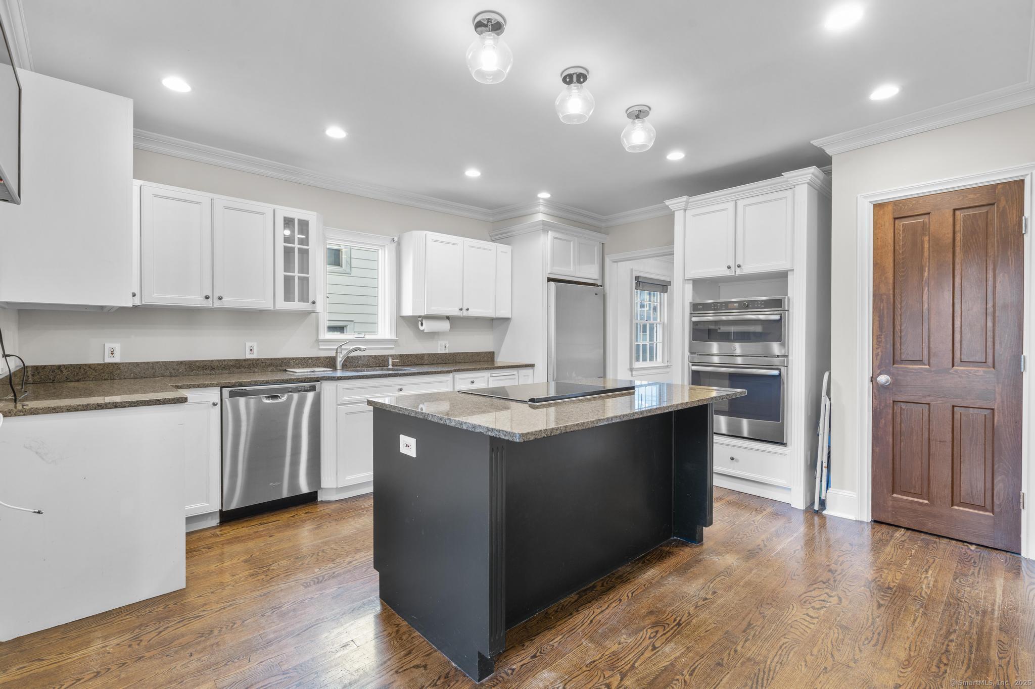 447 Reef Road Fairfield, CT 06824 - Photo 10 of 27 a kitchen with stainless steel appliances granite countertop a stove and a refrigerator