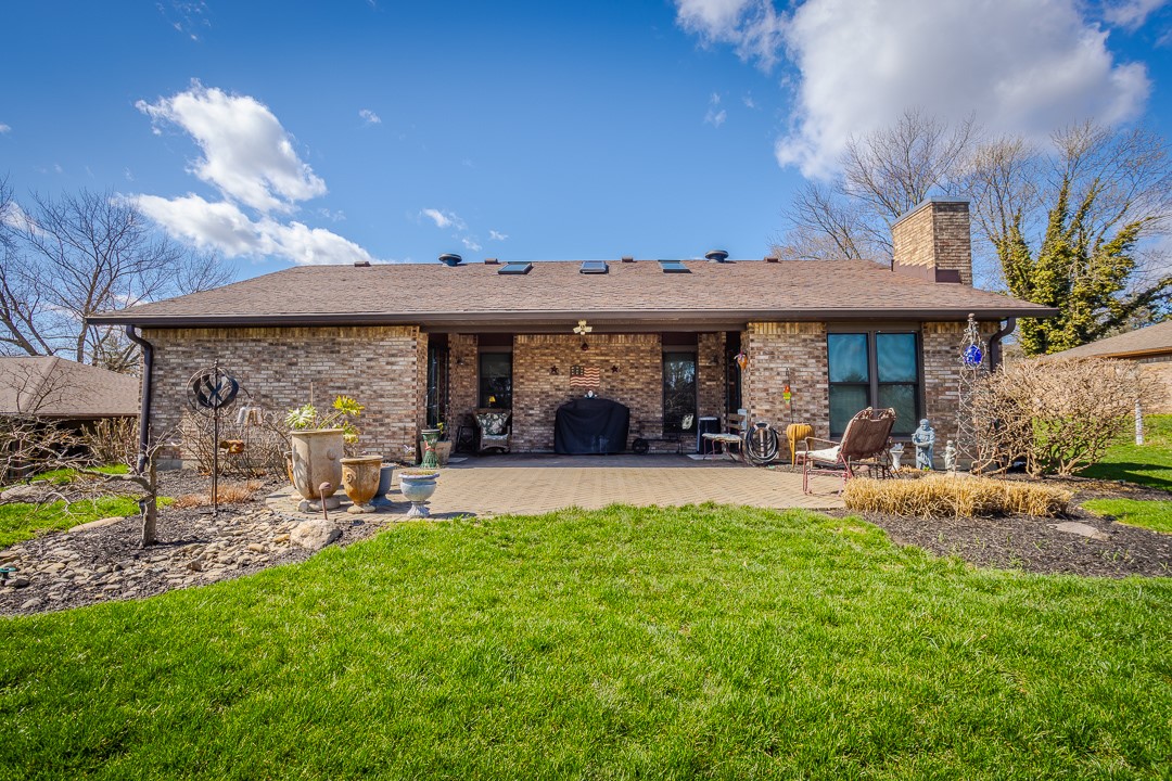 540 Basil Street Springboro, OH 45066 - Photo 26 of 32 This outdoor living area features a spacious patio and lush lawn, perfect for relaxation and entertaining.