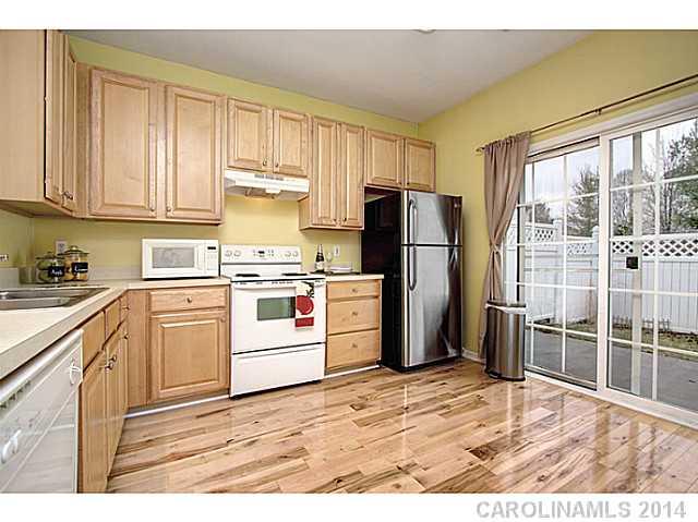 918 Azurine Circle, Unit 918 Fort Mill, SC 29708 - Photo 11 of 15 a kitchen with a refrigerator stove and wooden cabinets