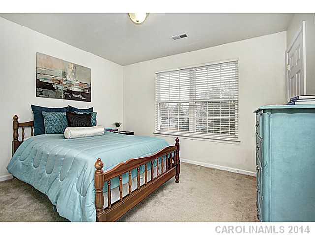 918 Azurine Circle, Unit 918 Fort Mill, SC 29708 - Photo 4 of 15 a bedroom with a bed a window and painting on the wall