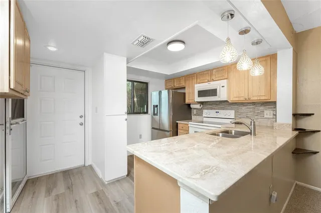 a view of a car parked in front of a brick house