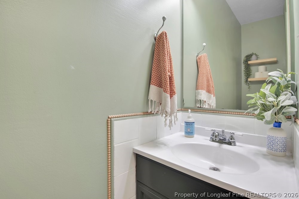 419 Senter Lane Bunnlevel, NC 28323 - Photo 16 of 49 a bathroom with a sink and a mirror