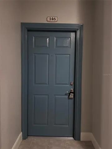 a view of an empty room with wooden floor and closet area