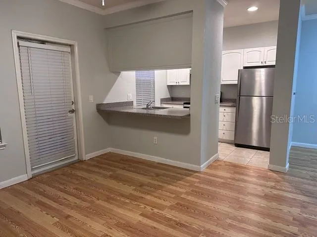 a kitchen with granite countertop cabinets and refrigerator