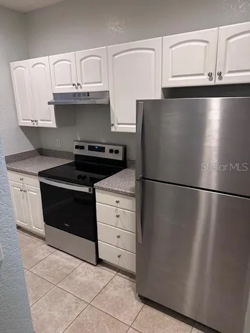 a kitchen with stainless steel appliances a refrigerator and a stove