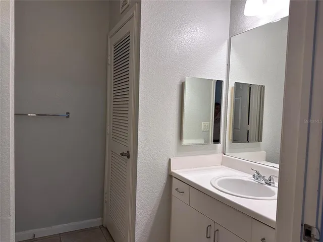 a bathroom with a granite countertop toilet and a shower