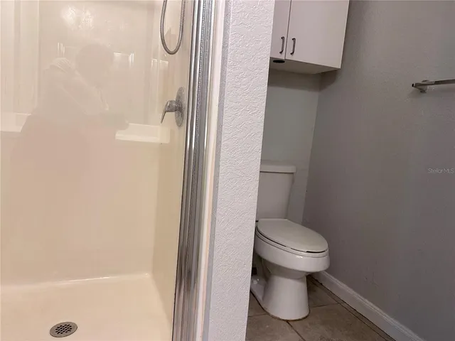 a bathroom with a glass shower door